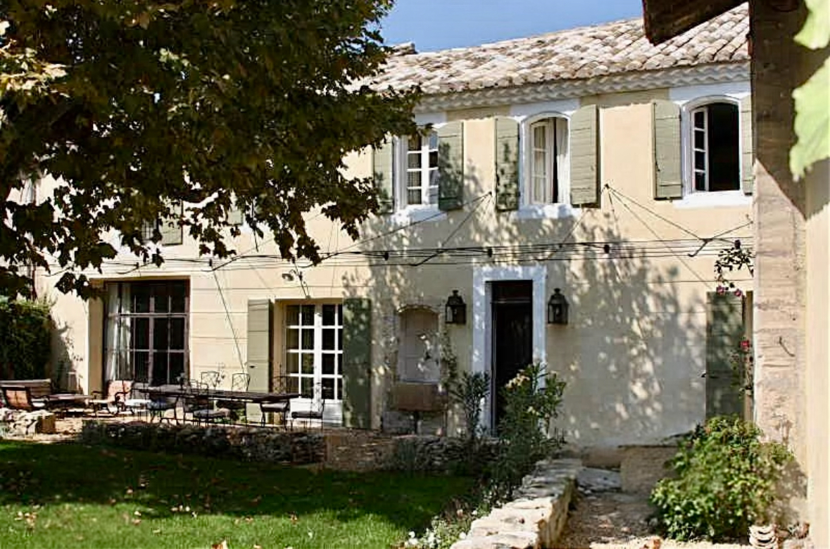 Provençal stone house exterior with shutters and garden